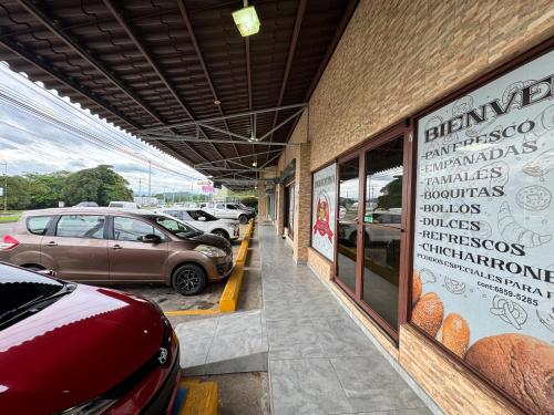 a building with cars parked in a parking lot at Apartamentos Alta Vista David in David