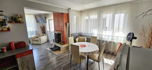 a kitchen and living room with a table and chairs at Апартамент При Рени in Koprivshtitsa