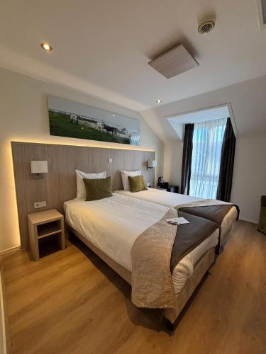 Postel nebo postele na pokoji v ubytování Hotel Herberg de Linden