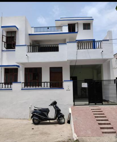 a scooter parked in front of a building at MOTA HOUSe in Jāmb