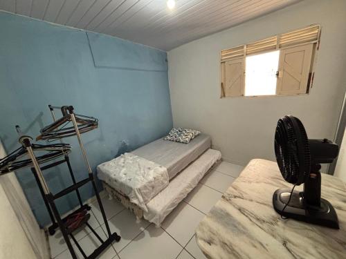 a room with a room with a bed and a window at Casinha Sol e Mar in Extremóz