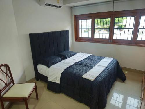 a bed in a room with a chair and a bed sidx sidx sidx at Guest house with AC close to Historical Centre 2 in Cartagena de Indias