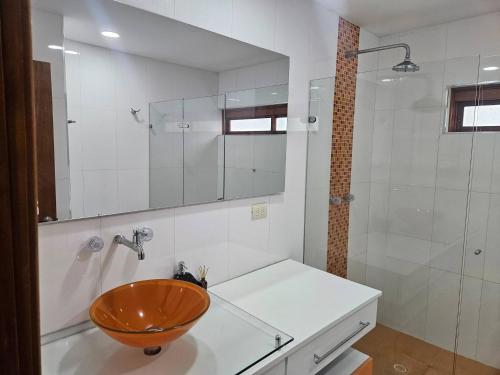 a bathroom with a wooden bowl sink and a shower at Guest house with AC close to Historical Centre 2 in Cartagena de Indias