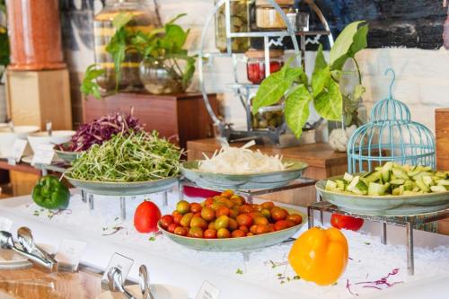 a bunch of bowls of vegetables on a counter at Tropical Ocean Escape Nha Trang in Nha Trang