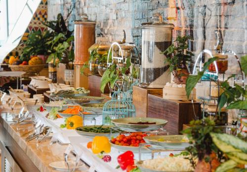 a buffet with plates of food on a table at Tropical Ocean Escape Nha Trang in Nha Trang