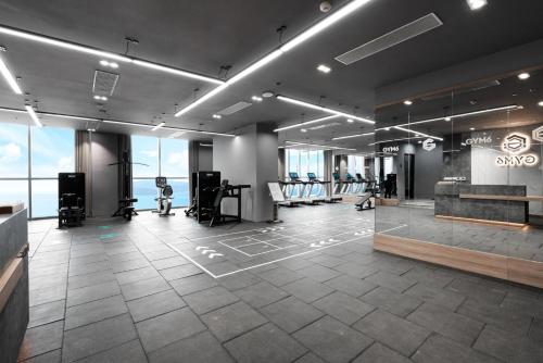 a large room with a gym with windows at Tropical Ocean Escape Nha Trang in Nha Trang