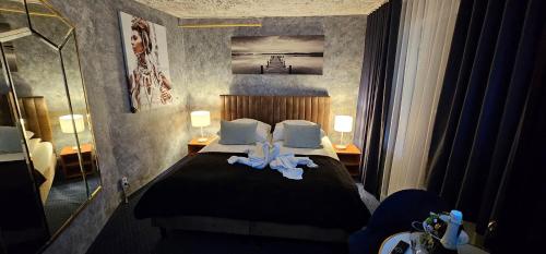 a bedroom with a bed with towels on it at ZAJAZD ALBATROS Rzeszów SPA in Rzeszów