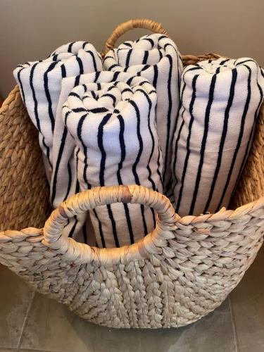 two baskets filled with towels sitting on a floor at Algonquin Waterfront and Winter Paradise With Sunsets in Algonquin Highlands