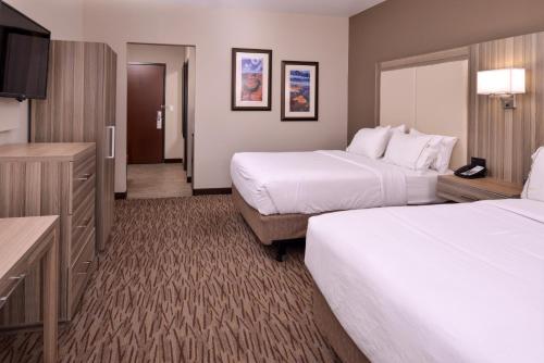 a hotel room with two beds and a flat screen tv at Holiday Inn Express & Suites Williams by IHG in Williams