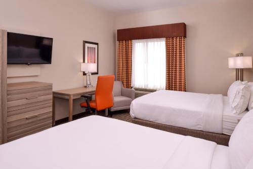 a hotel room with two beds and a desk at Holiday Inn Express & Suites Williams by IHG in Williams
