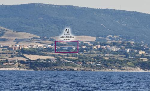 an air australia sign flying over a body of water at Abbaidda Hotel in Valledoria