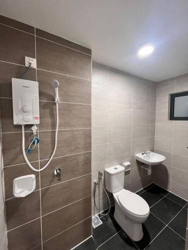 a bathroom with a shower and a toilet and a sink at edusentral prince suits in Shah Alam