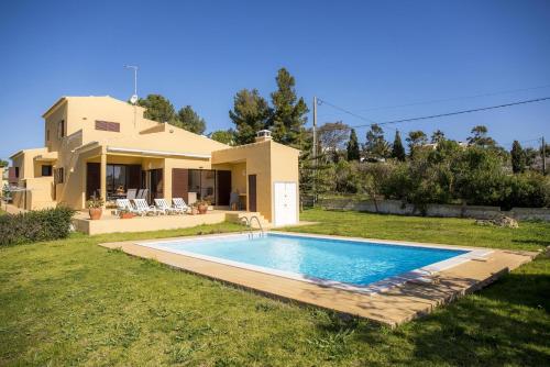 a villa with a swimming pool in front of a house at D05 - Amadeus Sunset Villa in Mato Porcas