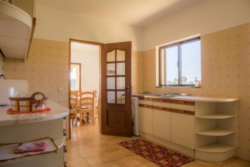 a kitchen with a sink and a window and a door at D05 - Amadeus Sunset Villa in Mato Porcas