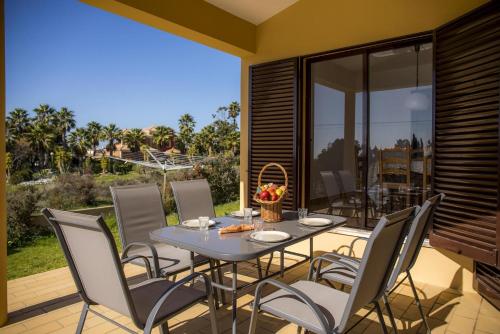 a dining room with a table and chairs on a patio at D05 - Amadeus Sunset Villa in Mato Porcas