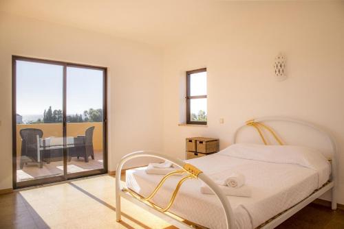 a white bedroom with a bed and a balcony at D05 - Amadeus Sunset Villa in Mato Porcas