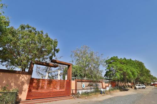 a building with a wooden gate on the side of a street at Hotel O Milan Party Hall in Vadodara