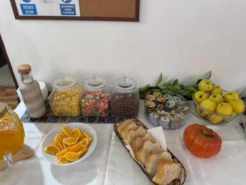 a table topped with bread and fruit and other foods at Hotel Bliss Aksu in Bucharest