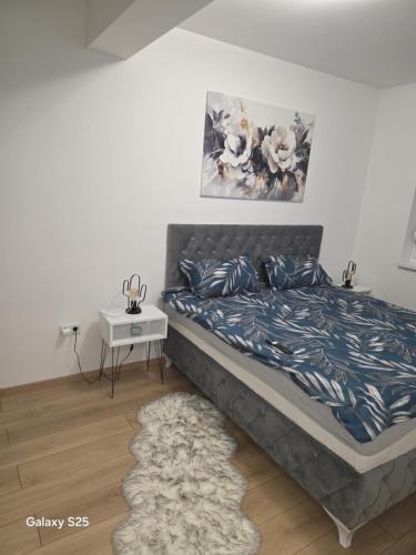 ブルチコにあるModern Apartment MOMENTのベッドとナイトスタンド付きのテーブルがある寝室