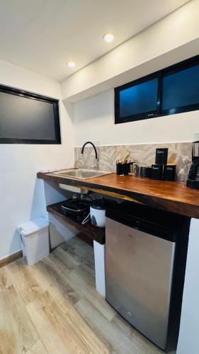 a kitchen with a counter top and a sink at Cabinas en Huacas y brasilito in Matapalo