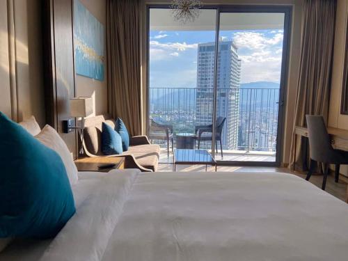 a hotel room with a large bed and a large window at Tropical Ocean Escape Nha Trang in Nha Trang