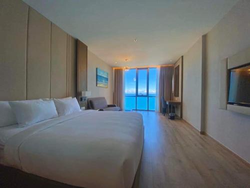 a large white bed in a hotel room at Tropical Ocean Escape Nha Trang in Nha Trang
