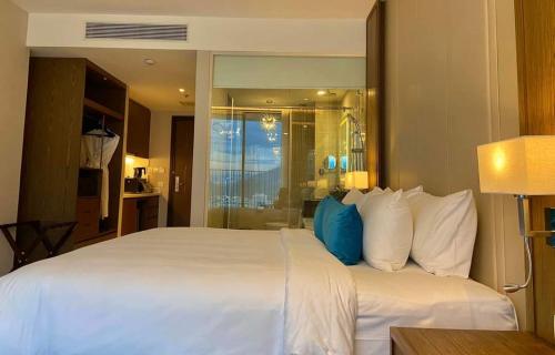 a large white bed in a hotel room at Tropical Ocean Escape Nha Trang in Nha Trang