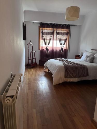 a bedroom with a large bed and a window at Jose s place in Alfena