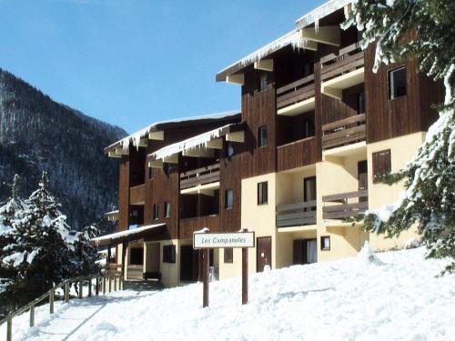 a large building with a sign in the snow at Résidence Les Campanules - LES CAMPANULES - CA11FC MAE-3147 in Villarodin-Bourget