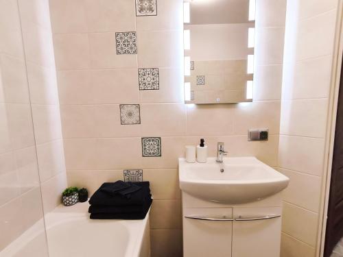 a small bathroom with a sink and a shower at SDH 3 Wolomin comfortable apartment near Warsaw in Wołomin