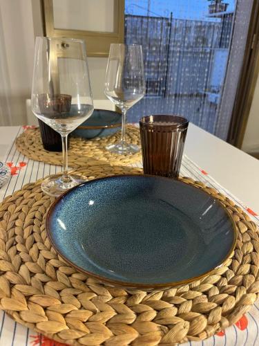 a plate and two wine glasses on a table at Casa A'Bareis in Polignano a Mare