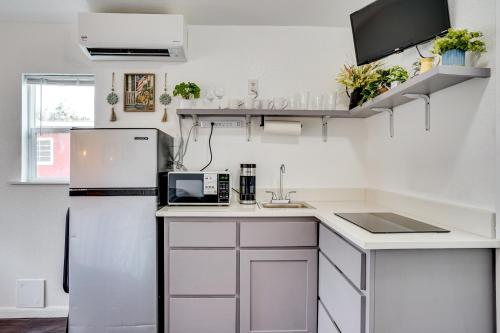 a kitchen with white cabinets and a refrigerator at Cozy Country Living Cabin in SlidellandDecatur! in Decatur