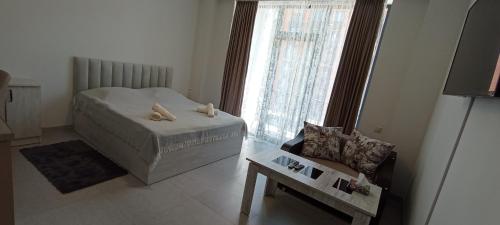 a bedroom with a bed and a chair and a window at New Alvina in Tsaghkadzor