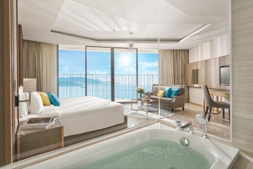 a hotel room with a bed and a bath tub at Tropical Ocean Escape Nha Trang in Nha Trang