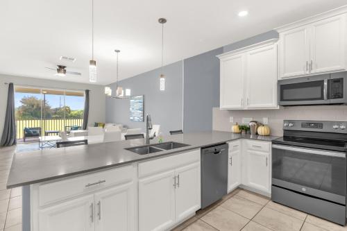 a kitchen with white cabinets and a counter top at Champion gate townhome in Kissimmee