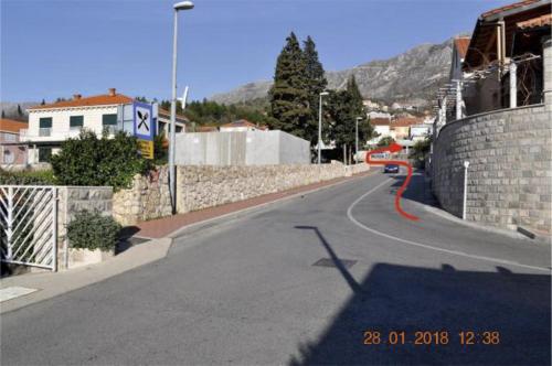 an empty street with a stone wall and a road at Župa Dubrovačka Guest House in Mlini