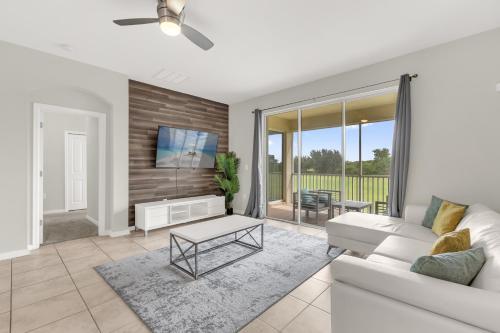 a living room with a couch and a tv at Champion gate townhome in Kissimmee