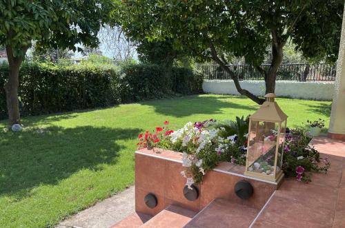 a garden with a box of flowers and a lantern at Pelion Malaki- Casa Verde in Malaki