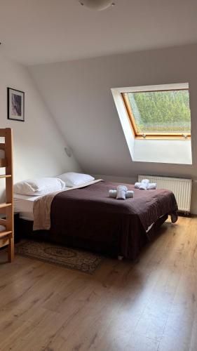 a bedroom with a large bed with a window at Gasthof Durigon in Ramingstein