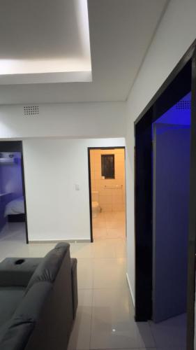 a living room with a couch and a blue door at Made Stays in Four Ways