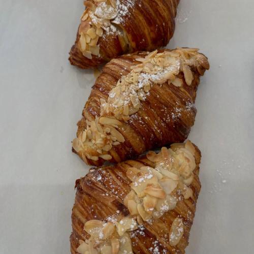 three croissants on a white plate with powdered sugar at Affittacamere Gess in Montalto Uffugo