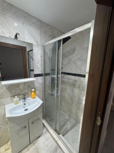 a bathroom with a shower and a sink at stone house marathounta in Marathounda