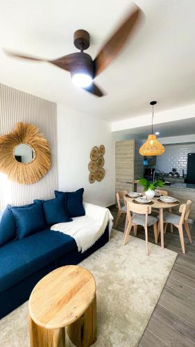 a living room with a blue couch and a ceiling fan at Modern, Comfortable, Close to Beaches in Colorado
