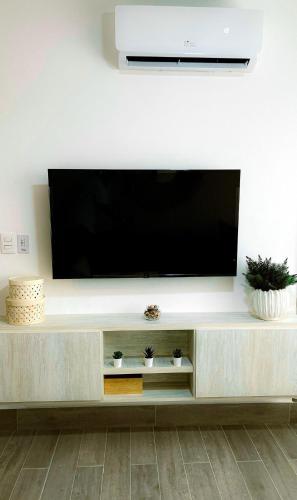 a large entertainment center with a flat screen tv at Modern, Comfortable, Close to Beaches in Colorado