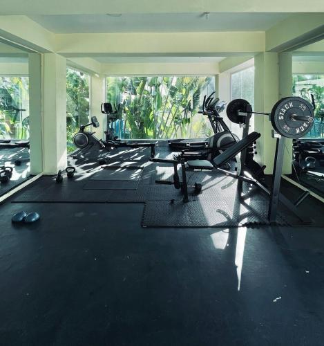 a gym with cardio equipment in a room at Modern, Comfortable, Close to Beaches in Colorado