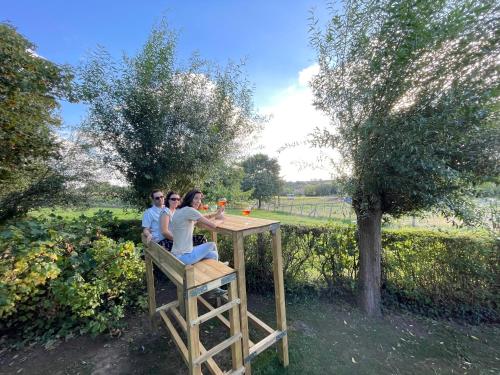 a group of three people sitting at a table at Vakantiewoning & Fietslogies V E L O, Tussen Hasselt en Maastricht in Bilzen