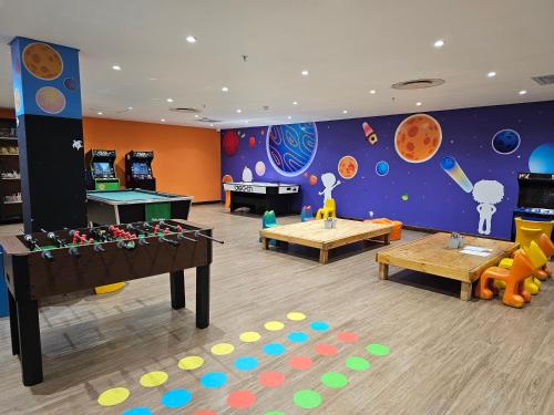 a childrens play room with a table and games at Zimbali Suites 108 in Ballito