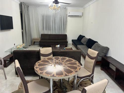 a living room with a couch and a table at Garden view 3 BR 2 balconies in compound in Obour
