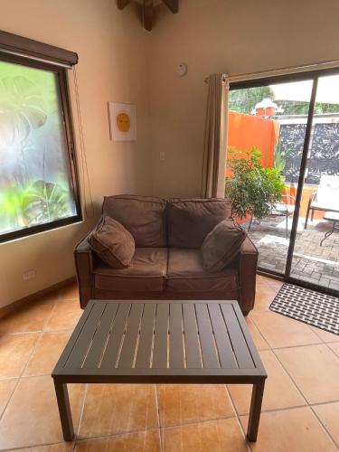 a living room with a couch and a coffee table at Beachy Studio Hideaway Steps to Sand & Sunset in Playa Flamingo