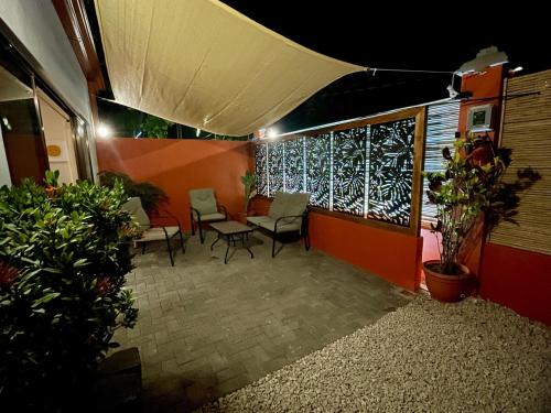 a room with chairs and a table and a window at Beachy Studio Hideaway Steps to Sand & Sunset in Playa Flamingo
